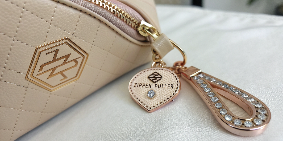 Hardware and zipper puller details for Beauty GWP cosmetic bags