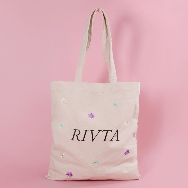 Luxury 16oz organic cotton tote bag with embroidered logo for a beauty brand.