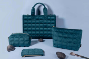 A collection of stylish recycled PET makeup bags in various colors and textures