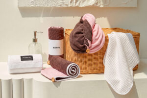 Two custom hair towel routes for beauty GWP: a two-tone button-loop turban and a white waffle elastic-wrap construction