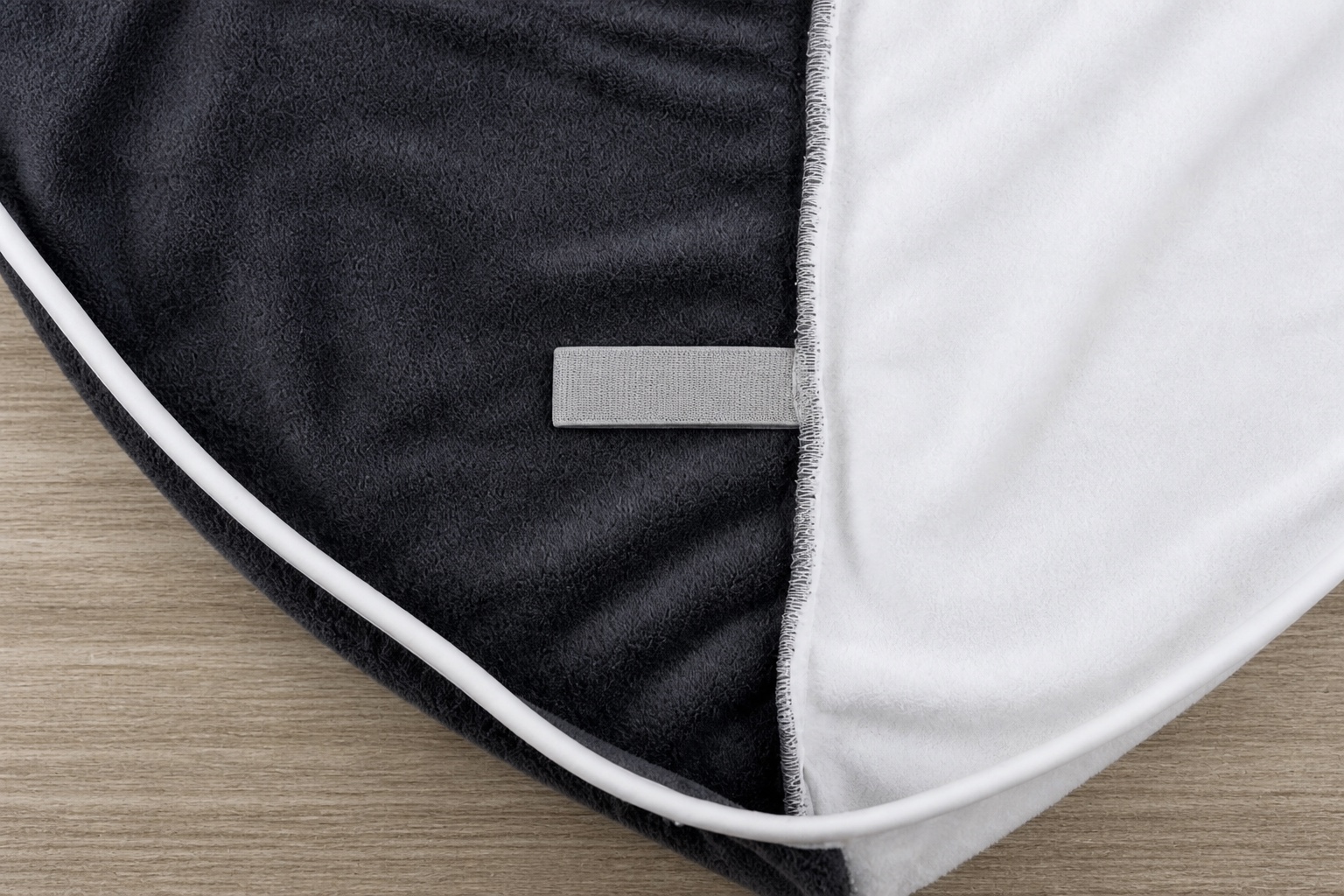 Microfiber hair turban construction detail showing edge binding, seam and narrow branding area