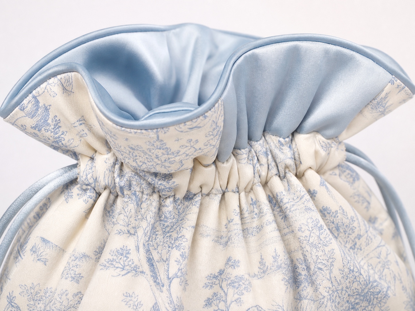 Ruched satin pouch gathered channel with contrast lining and cord exit detail