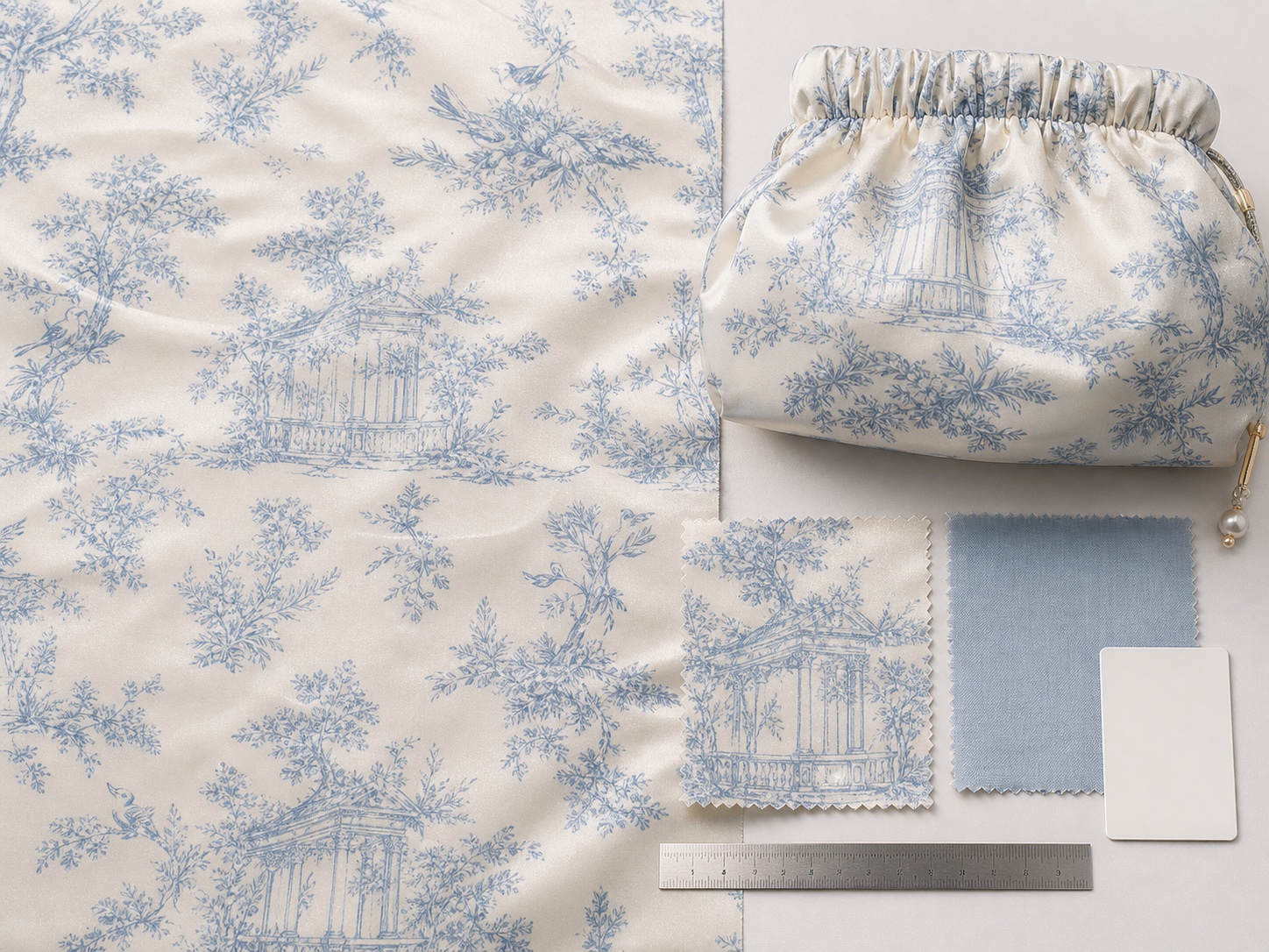 Toile print strikeoff and gathered satin pouch sample for motif repeat approval