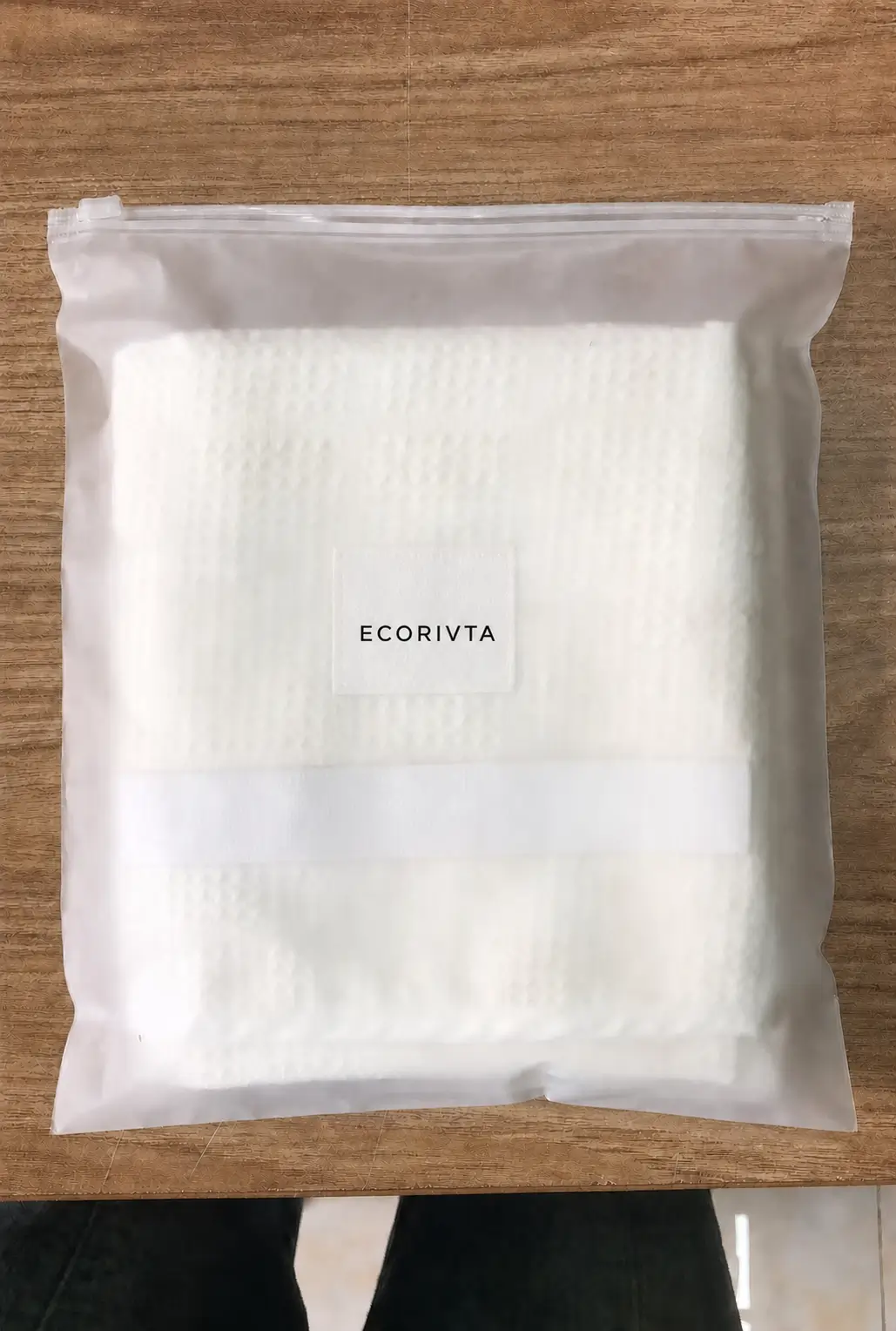 White waffle elastic-wrap hair towel sample in a translucent zipper bag with an Ecorivta presentation label